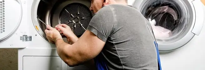 Dryer repair technician fixing a clothes dryer drum in St Paul, MN