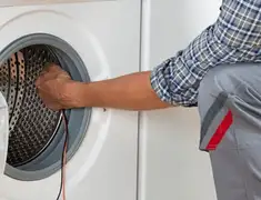 Dryer repair technician diagnosing and servicing a clothes dryer in St Paul, MN
