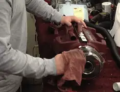 Vacuum repair technician cleaning and servicing a vacuum motor in St Paul, MN